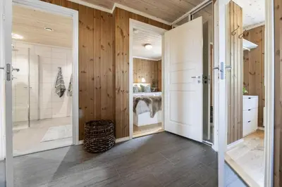 a bathroom with wooden walls and a shower and a toilet at Mountain Apartment By Trysil's Best Bike Trails in Trysil