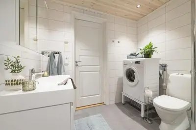 a white bathroom with a washing machine in it at Mountain Apartment By Trysil's Best Bike Trails in Trysil