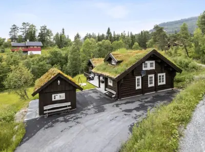 an image of two log homes with a grass roof at Timber Cabin With Soul At Kvamskogen in Norheimsund
