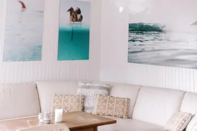 a living room with a white couch and a table at Kommahuset in Ervik