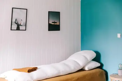 a living room with three pictures on the wall at Kommahuset in Ervik