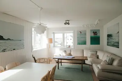 a living room with a couch and a table at Kommahuset in Ervik