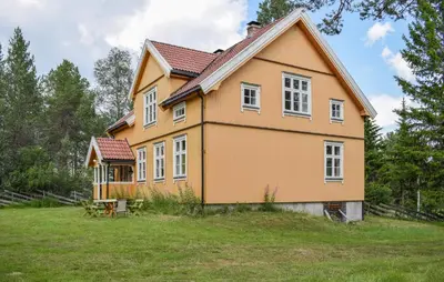 a yellow house on a grassy field at 7 Bedroom Lovely Home In Tufsingdalen in Bakken