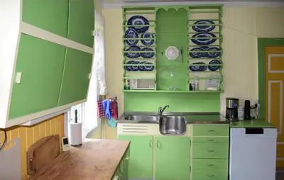 a small kitchen with green cabinets and a sink at 7 Bedroom Lovely Home In Tufsingdalen in Bakken
