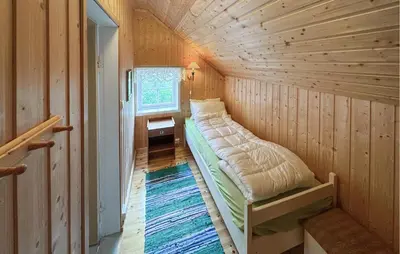a small room with a bed in a tiny house at 7 Bedroom Lovely Home In Tufsingdalen in Bakken