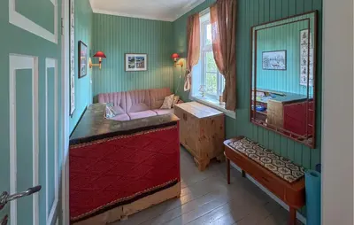 a living room with a pink couch and a mirror at 7 Bedroom Lovely Home In Tufsingdalen in Bakken
