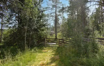 a wooden fence on a field with a path at 7 Bedroom Lovely Home In Tufsingdalen in Bakken