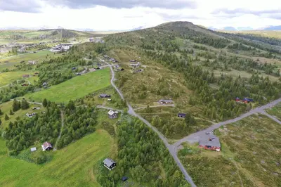 an aerial view of a village on a hill at Red Cross Cabin, Spacious mountain lodge in Gol