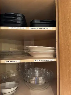 a cupboard filled with plates and bowls and other dishes at Red Cross Cabin, Spacious mountain lodge in Gol