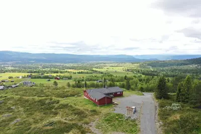 an aerial view of a red barn in a field at Red Cross Cabin, Spacious mountain lodge in Gol