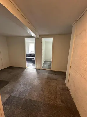 an empty room with an open door to a living room at Sula in Frøya