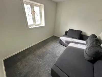 a living room with a couch and a window at Sula in Frøya