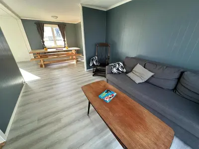 a living room with a couch and a table at Sula in Frøya