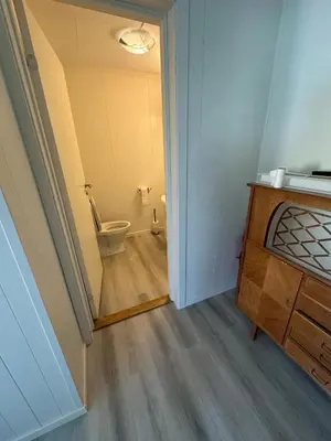 a bathroom with a toilet in a room at Sula in Frøya