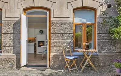 a table and chairs sitting outside of a house at Eden Oasis, Bakklandet with Free parking! in Trondheim
