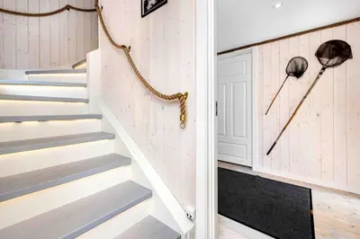 a staircase in a home with white walls at Raffelbrygga in Bud