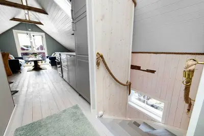 an attic hallway with a door to a room at Raffelbrygga in Bud