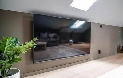 a large screen tv on a wall in a living room at Luxurious Home In Ytre Arna With Wifi in Ytre Arna