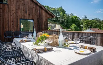 a table with a white table cloth on a patio at Luxurious Home In Ytre Arna With Wifi in Ytre Arna