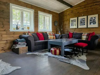 a living room with a couch and a table at Mountain Cabin With Views Of Bonsenås in Tuddal
