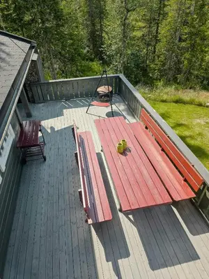 a deck with a bench and a chair on it at Mountain Cabin With Views Of Bonsenås in Tuddal