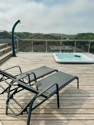 a deck with a bench and a swimming pool at Modern Cabin With Archipelago Views in Bremnes