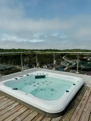 a hot tub sitting on top of a deck at Modern Cabin With Archipelago Views in Bremnes