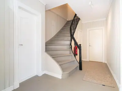 a staircase in a home with white walls at Sentralt beliggende enebolig på Møllenberg in Trondheim