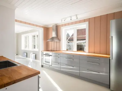 a kitchen with a stainless steel refrigerator and a window at Sentralt beliggende enebolig på Møllenberg in Trondheim