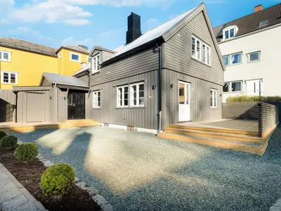 a black house with a porch and a deck at Sentralt beliggende enebolig på Møllenberg in Trondheim