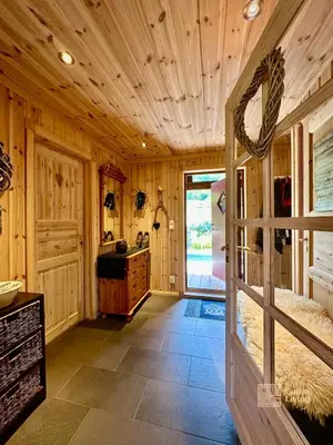 a kitchen with wooden walls and a wooden ceiling at Indoor hot tub, views & nature, cosy family cabin at Filefjell in Tyinkrysset