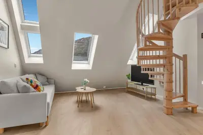 a living room with a staircase and a couch at 307SB10 - Three Bedroom Stay in Bergen