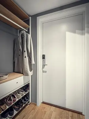 a walk in closet with a white door and shoes at Modern apartment in the middle of Bergen city center in Bergen