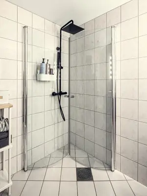 a shower with a glass door in a bathroom at Modern apartment in the middle of Bergen city center in Bergen
