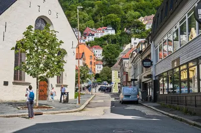 a man standing on the side of a city street at HD Central Topfloor in Bergen