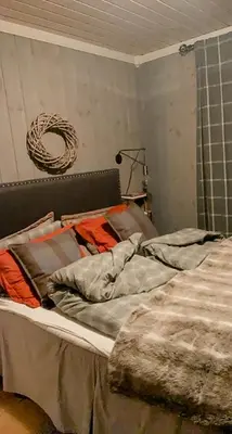 an unmade bed in a room with a rope at Log Cabin At The Foot Of Hallingskarvet in Hovet
