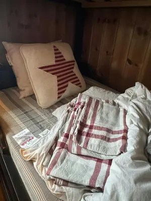 an unmade bed with a blanket and a pillow at Log Cabin At The Foot Of Hallingskarvet in Hovet