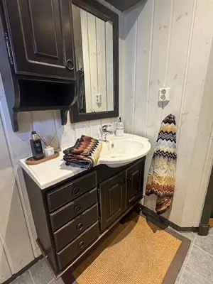 a bathroom with a sink and a mirror at Log Cabin At The Foot Of Hallingskarvet in Hovet
