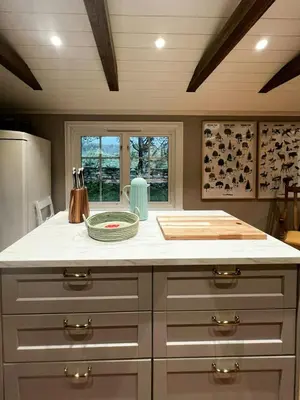 a kitchen with a white counter top and a window at Restored Farmhouse By The Sea In Kvalheim in Raudeberg