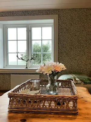 a vase of flowers on a table in a room at Restored Farmhouse By The Sea In Kvalheim in Raudeberg