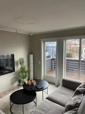 a living room with a couch and a table at Great and modern apartment at Grilstad Marina! in Trondheim