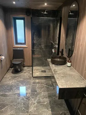 a bathroom with a sink and a shower and a toilet at Flott hytte i Sogndal skisenter-Hodlekve in Sogndal