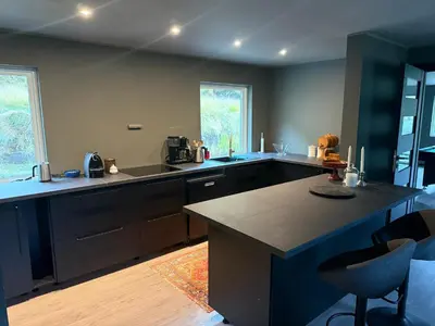 a kitchen with a large island in the middle at Fossen Bratte Mountain home in Eikedalen
