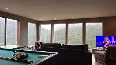 a living room with a pool table and a tv at Fossen Bratte Mountain home in Eikedalen