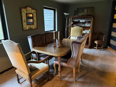 a dining room with a wooden table and chairs at Fossen Bratte Mountain home in Eikedalen