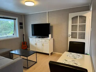 a living room with a couch and a television at Bergtun's Corner - Sotra Vest in Sekkingstad