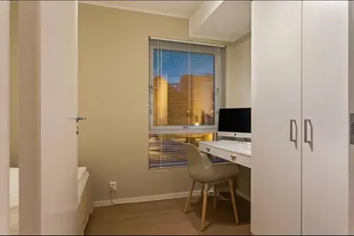 an office with a desk and a window and a chair at J og F in Bergen
