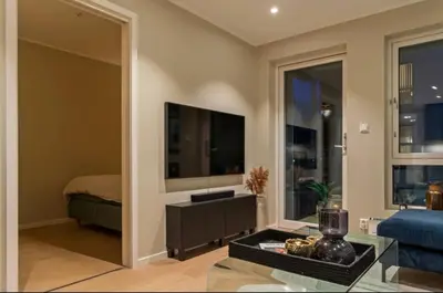 a living room with a large flat screen tv at J og F in Bergen