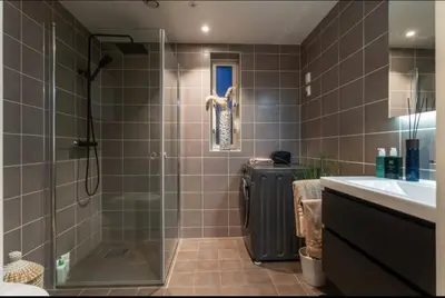 a bathroom with a shower and a sink at J og F in Bergen