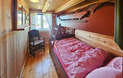 a small bedroom with a bed and a chair at Lovely Home In Røn With House A Mountain View in Ron